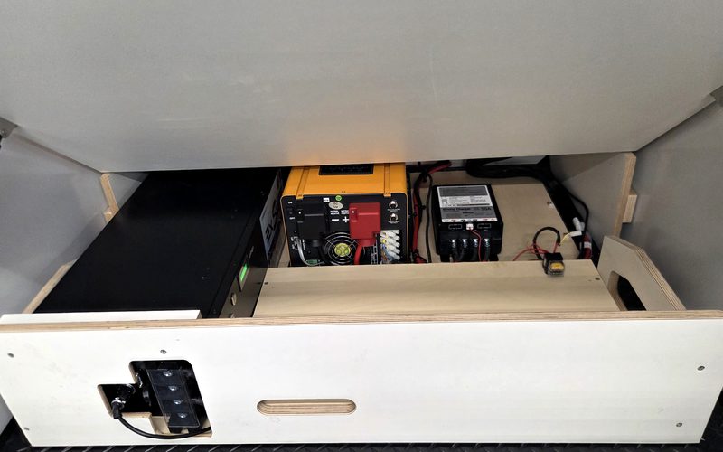 Inverter and charger inside the open lower storage cabinet