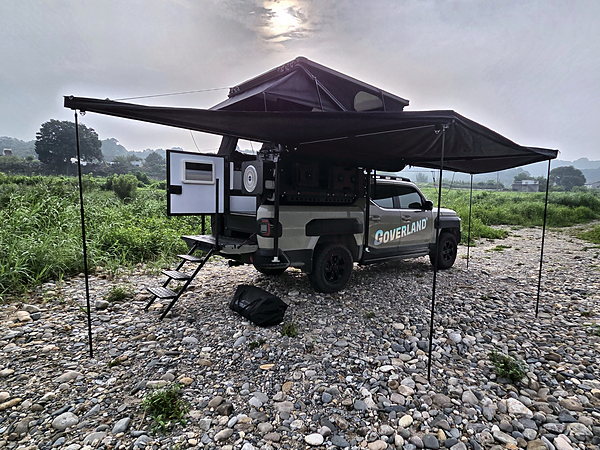 GOAT with the awning out by a river