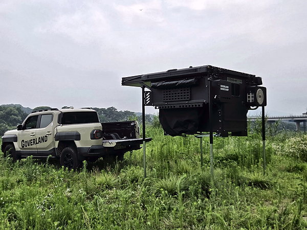 GOAT standing on its outriggers while the truck drives away